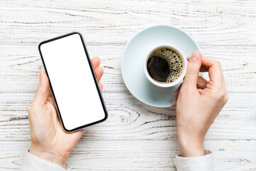 Top view of woman hands holding smart phone with blank copy space screen for your text message or information content. woman hand using phone white screen on top view