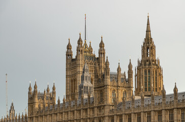 Fototapeta premium Palace of Westminster (the Houses of Parliament), its distinctive Gothic Revival architecture, characterized by intricate stonework and towering spires, This landmark serves as the meeting place for t