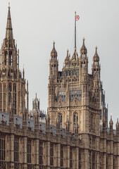 Palace of Westminster (the Houses of Parliament), its distinctive Gothic Revival architecture, characterized by intricate stonework and towering spires, This landmark serves as the meeting place for t
