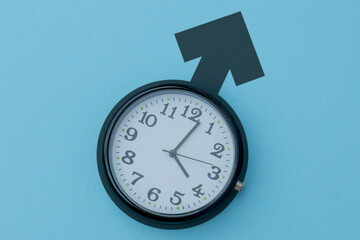 Clock on a blue background with a male gender symbol. Biological clock, aging, health issues, andropause, low testosterone concept.