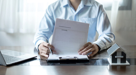 cagents working in real estate investment and home insurance signing contracts in accordance with the home buying insurance agreements approving purchases for clients
