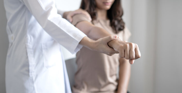 Female physiotherapists provide physical assistance to woman patients with shoulder injuries massaging their shoulders for muscle recovery in the rehabilitation center. Physiotherapy concepts