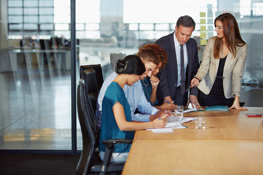 Business training, manager and advice in office for career development, internship and feedback. Mentorship, people and interns with documents in boardroom for company policy or corporate improvement