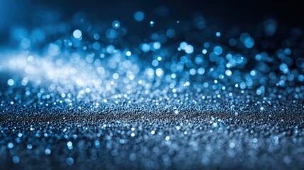Blue Glitter Sparkling on Dark Surface Creates a Magical, Abstract Background with Defocused Bokeh