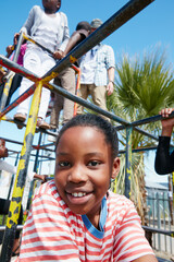 Child, portrait and smile on jungle gym at park for playing, holiday activity and development....