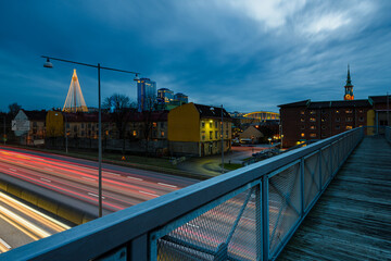 Light trails on motorway in Gothenburg with buildings and holiday lights in the evening sky