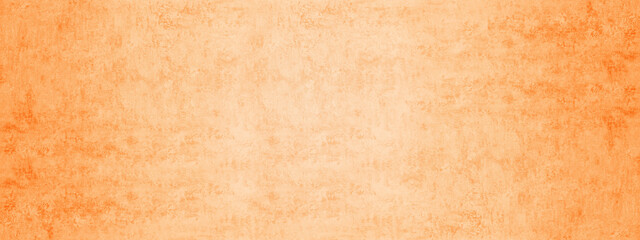 Textured abstract background of an aged cement or stucco wall in distressed bright orange-peach color with rough mottled finish suitable for rustic grunge or decorative overlay effects