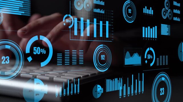 Close-up view of hands typing on a keyboard with holographic digital graphs and charts in a dark environment, representing modern data analysis and business visualization. Xenic