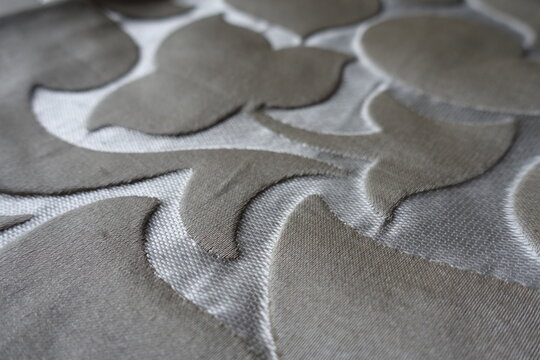 Closeup of beige and silver single damask jacquard fabric