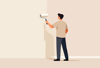 A person, viewed from behind, paints a wall with a roller. The shadow falls on the beige floor