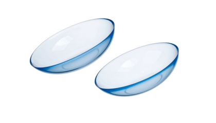Two clear, concave spherical objects with a blue hue around the edges, likely ocular aids, rest on a black background