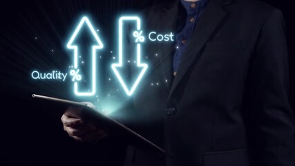 A businessman in a dark suit holds a tablet displaying glowing arrows representing quality and cost fluctuations, symbolizing financial analysis and strategic planning. Qubit - Powered by Adobe