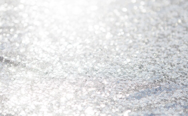 Abstract blurred light bokeh on grey background, festive season concept background, blank silver bokeh