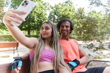Happy couple taking selfie after workout in park
