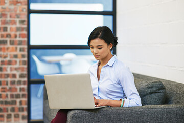 Business, hiring and woman on couch, laptop and typing with online application for job interview. Person, candidate and employee pc, waiting and email notification with research for company vacancy