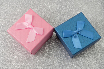 Colorful gift boxes with ribbons on shiny surface