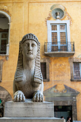 Close-up of Stone Sphinx Statue Against Yellow Historic Building Facade, Palma de Mallorca