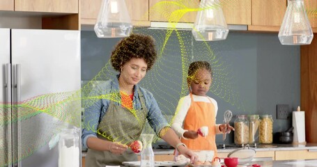 Adult female scooping batter, guiding child measuring and pouring into muffin tin, teaching baking - Powered by Adobe