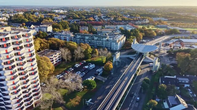 High-angle aerial view of modern structure La Poterie multimodal transit hub and elevated metro station of Rennes Metro line A, located in La Poterie Le Blosne area in the south‑east of Rennes, France