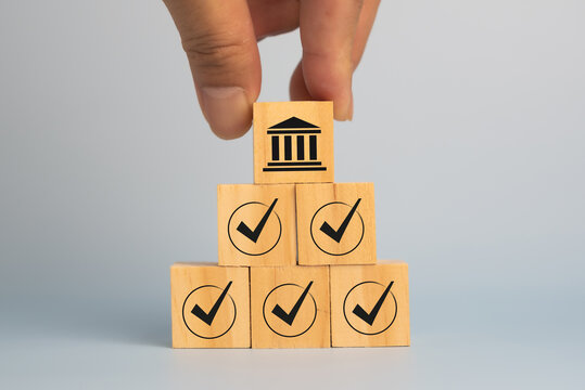 Regulation and good governance for transparent, accountable, and sustainable business operations. Wooden blocks with check marks, symbolizing corporate regulatory and compliance, ethical corporate.