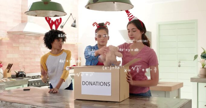 Three women packing donations box in kitchen, center lifting blanket and causing floating equations