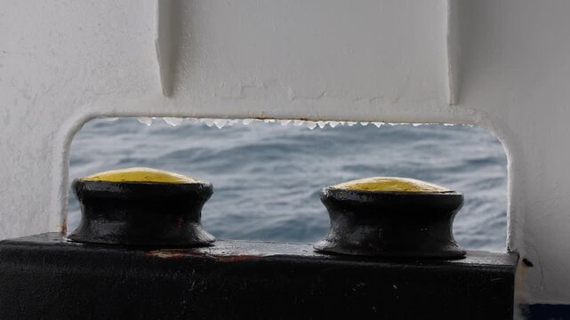 Vessel's mooring fairlead with slow moving water in the background