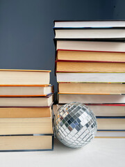 stack of books with a disco ball