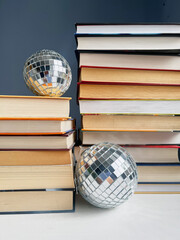 stack of books with a disco ball