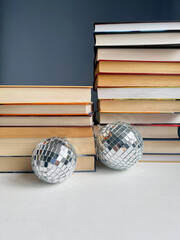 stack of books with a disco ball