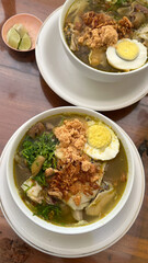 rice with chicken soto and egg. soto ayam served with white rice, Indonesian traditional chicken soup