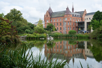 View of the castle where the Malm&ouml; library is located, and its reflection on the calm water of a lake.