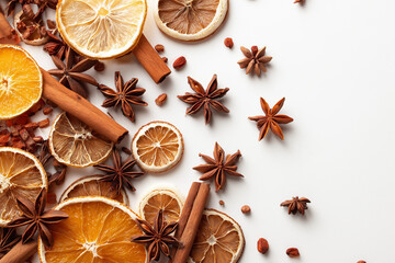 Mixed dried winter spices and citrus fruit slices flat lay isolated on white background. Top view of cinnamon, star anise and ingredients for mulled wine