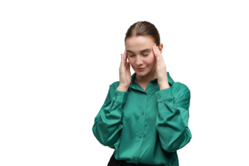 Woman holds head with hands indoors at a desk