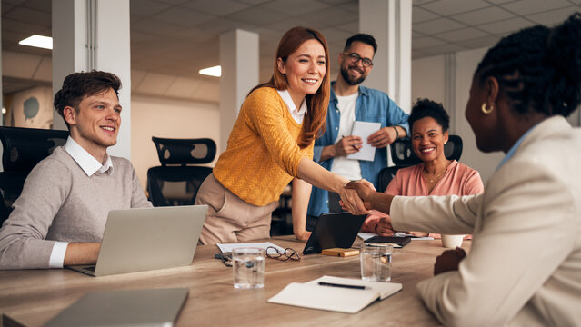 Team Celebrating Collaboration During a Business Meeting in a Modern Office