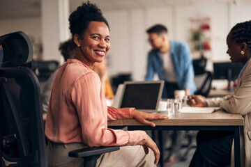 Smiling Professional Woman During Collaborative Office Meeting with Colleagues