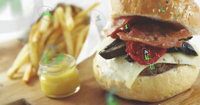 Faint spark appearing then green icons drifting over cheeseburger fries and jar highlighting flavor