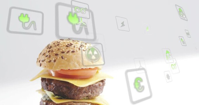 Top bun appearing, camera shifting, revealing cheeseburger while eco-icons floating, showing green
