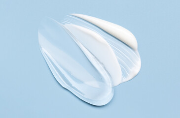 Close-up of cosmetic smear of creamy texture on gray background, blue background