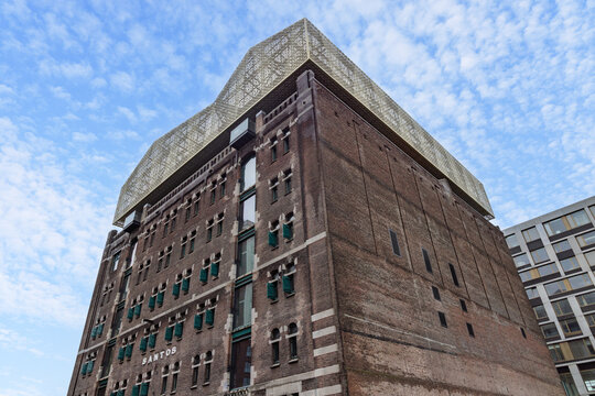 Exterior view of the historic Santos warehouse, now the Nederlands Fotomuseum, featuring a renovated facade and gold rooftop structure.  Rotterdam Netherlands, 15 November 2025.