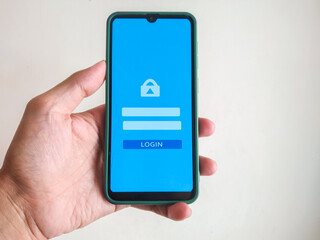 mobile phone with login page in hand