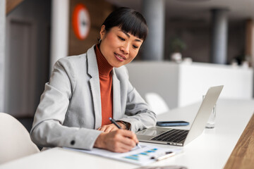 Professional Woman Analyzing Business Data in an Office Setting