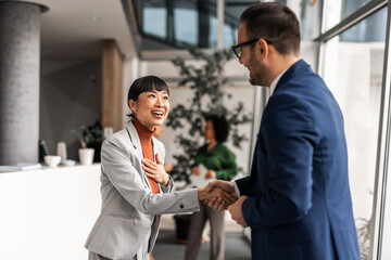 Business Professionals Shaking Hands in a Modern Office Setting