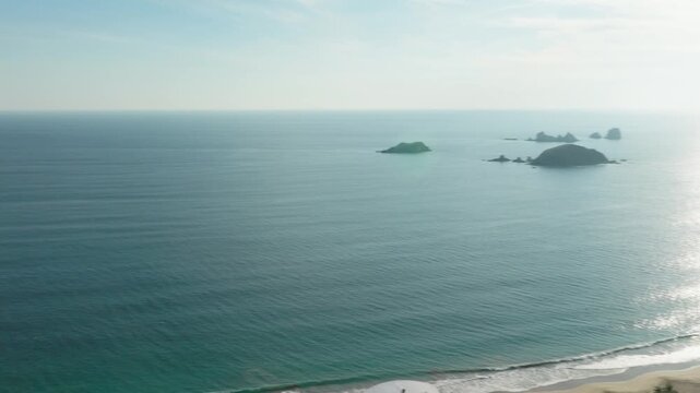 DRONE: PANNING SHOT OF THE BEACH OF IXTAPA AT SUNSET