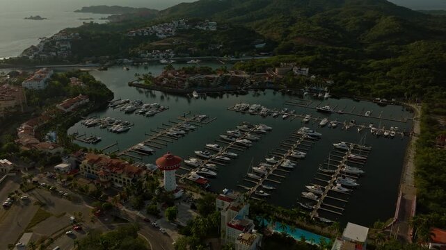 DRONE: HIGH ALTITUDE DRONE SHOT OF IXTAPA, ZIHUATANEJO MARINA AT SUNSET IN MEXICO