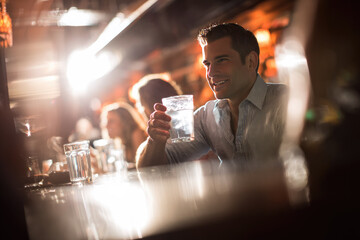 Designated driver enjoying water at bar with friends, smiling and relaxed atmosphere, responsible choice for safe transportation after social gathering