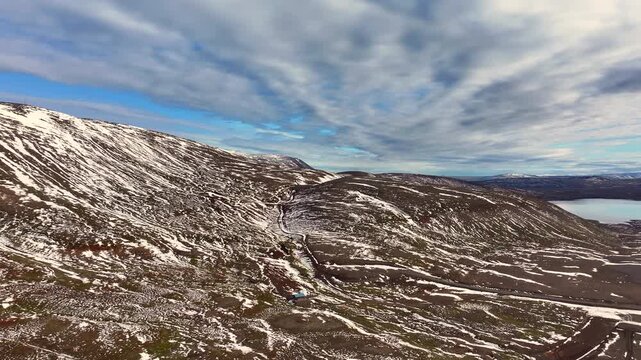 Aerial view of a scenery with partly snow covered mountains near Husavik - Iceland