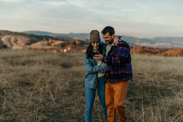 Couple hiking in nature looking at smartphone