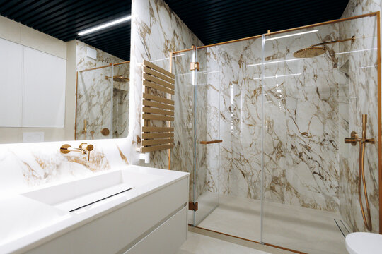 Opulent washroom featuring stone walls and reflective mirror