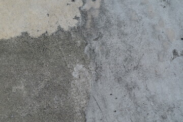 Textured Surface of Concrete with Distinct Patterns and Colors on Wall