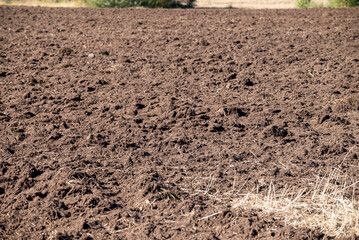 Freshly Plowed Brown Earth Field Ready For Planting.
